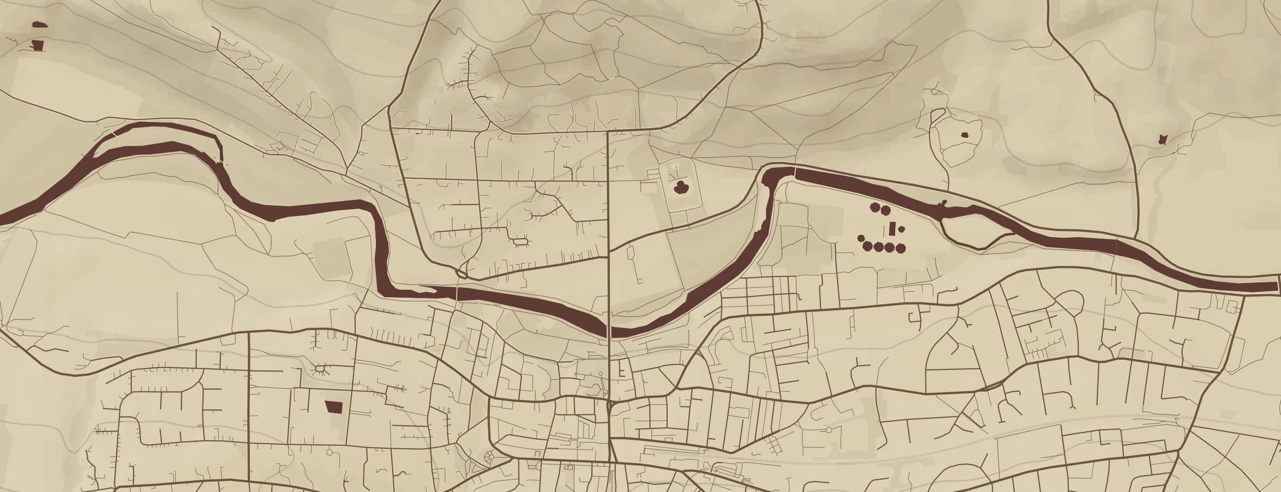 A close crop of a printed map: individual streets, field boundaries, the river and contour shading